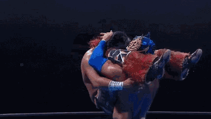 two men are wrestling in a ring with a sign that says lbck