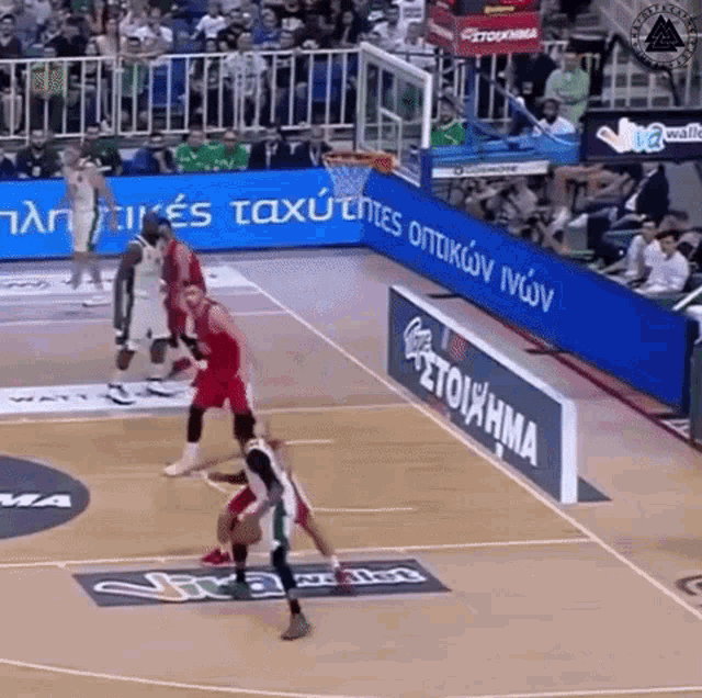 a basketball game is being played on a court that has a sign that says stoiathma