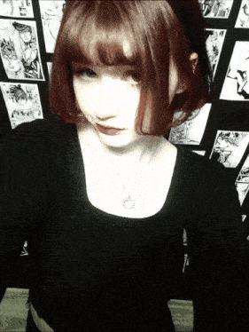 a girl with red hair is wearing a black shirt