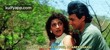 a man and a woman are standing next to each other and the man is saying `` happy birthday to you dearest hana '' .