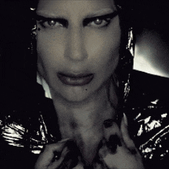 a close up of a woman 's face with a dark background