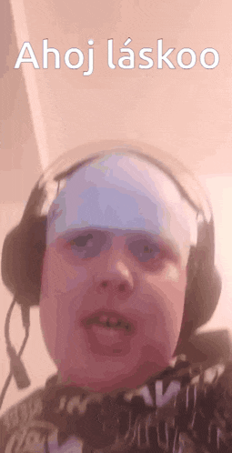 a young boy wearing headphones and a bandage on his head says ahoj laskoo