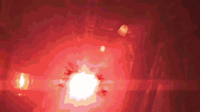 a blurred image of a red light with a white circle in the center