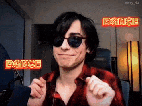 a man wearing sunglasses and a red plaid shirt is dancing with the words dance behind him