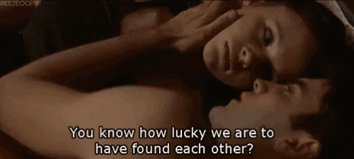 a man and a woman are laying next to each other with the words you know how lucky we are