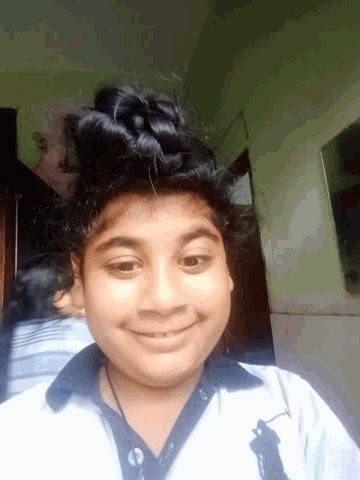a young girl wearing a polo shirt is smiling