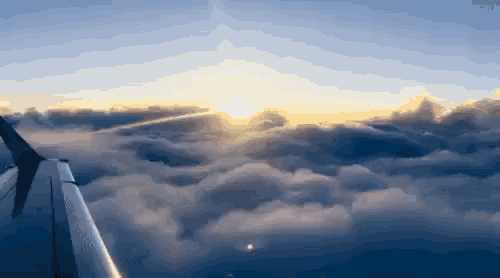 the sun is shining through the clouds above the wing of a plane