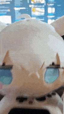 a close up of a stuffed animal with sunglasses on