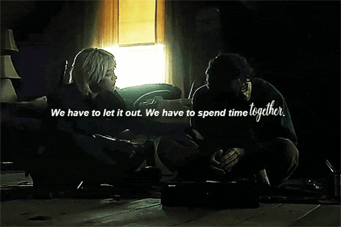 a couple sitting on the floor with the words we have to let it out