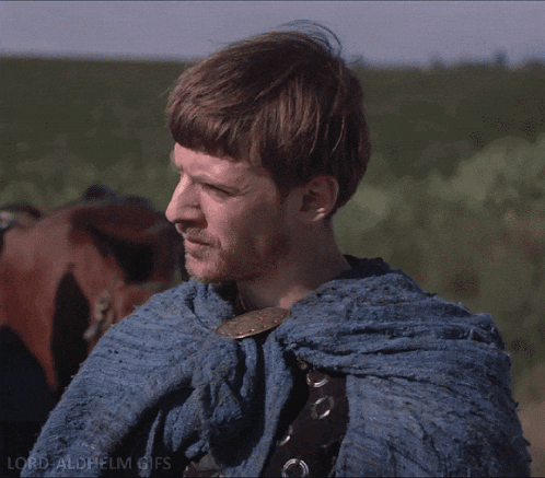 a man is wearing a blue cape with the words lord aldhelm gifs below him