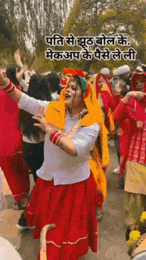 a woman in a red skirt is dancing with a group of people in a crowd .