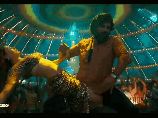 a man and a woman are dancing together in a club
