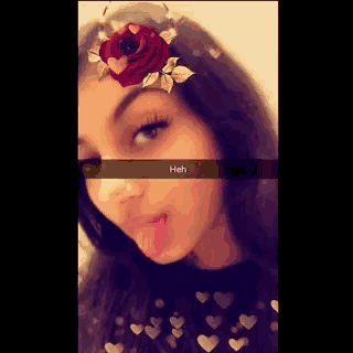 a girl with a red rose in her hair has a snapchat filter on her face that says heh