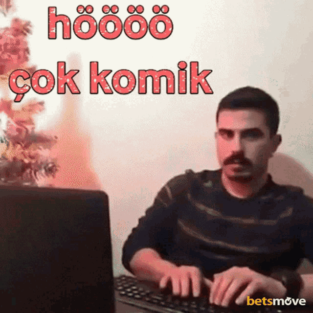 a man with a mustache is typing on a keyboard with the words hoööö çok komik written above him