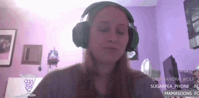 a woman wearing green headphones in a purple room