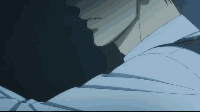 a close up of a man 's face in a white shirt