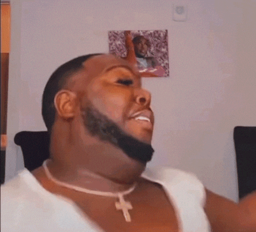 a man with a beard is wearing a cross necklace