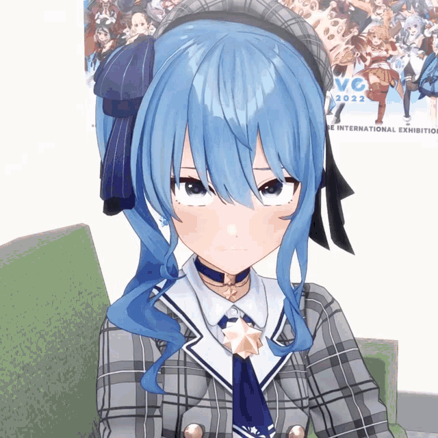 a girl with blue hair is sitting in front of a poster for the international exhibition 2022