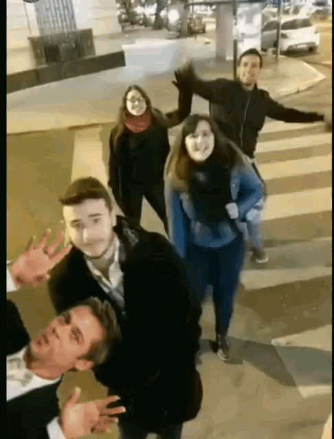 a group of people are posing for a picture in a crosswalk