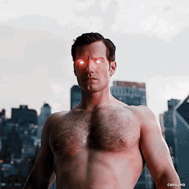 a shirtless man with red eyes stands in front of a cityscape