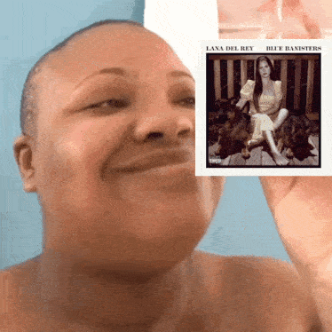 a woman holding up a lana del rey album cover