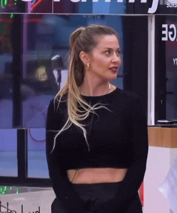 a woman in a black crop top stands in front of a sign that says ' 30 '