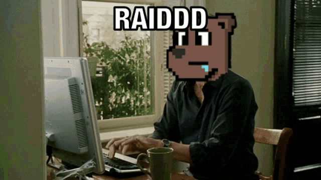 a man sitting in front of a computer with the words raiddd written on the screen