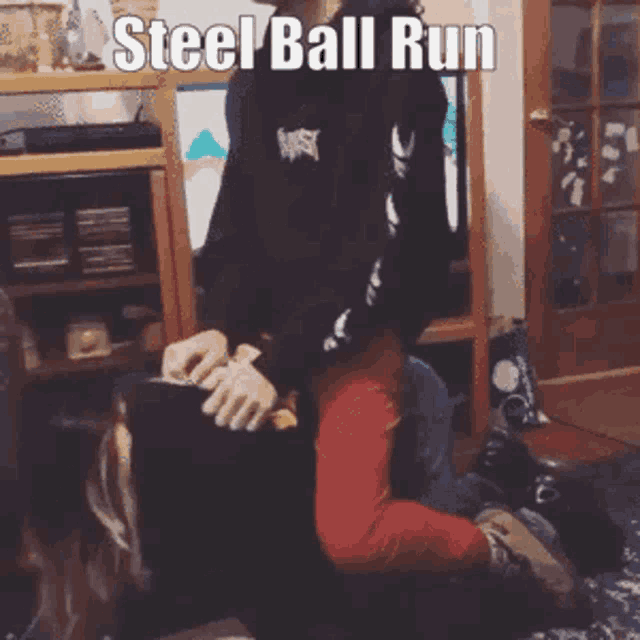 a person is sitting on another person 's lap with the words steel ball run written on the bottom