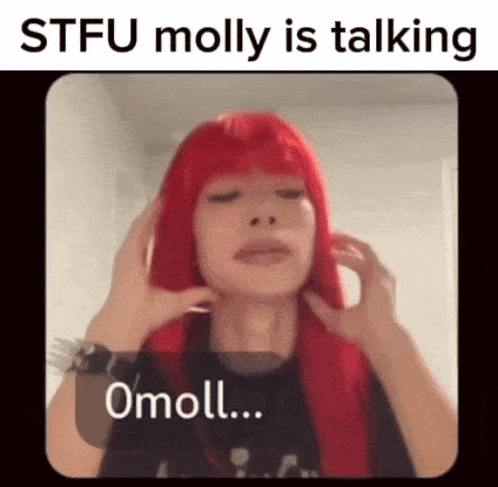 a woman with red hair is talking to someone while wearing a black shirt .