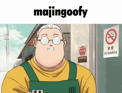 a man with glasses and an apron is standing in front of a no smoking sign