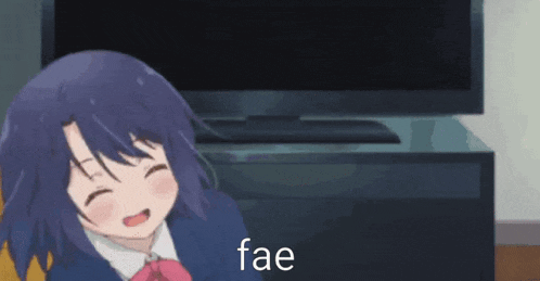 a girl with purple hair is sitting in front of a television and laughing .