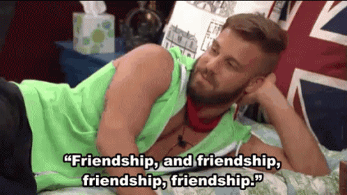 a man with a beard is laying on a bed with a quote about friendship .