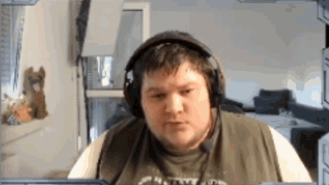 a man wearing headphones and a shirt that says metallica on it