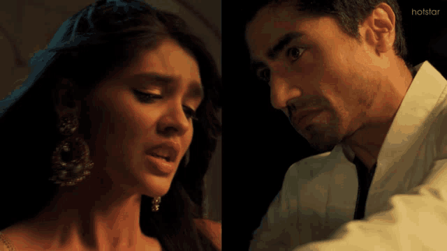 a man and a woman are looking at each other with the words hotstar on the bottom right