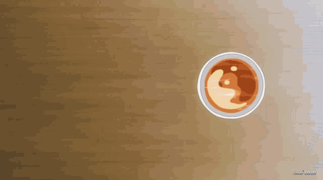 a cartoon drawing of a cup of coffee on a brown surface