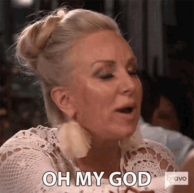 a woman says " oh my god " while wearing a white top