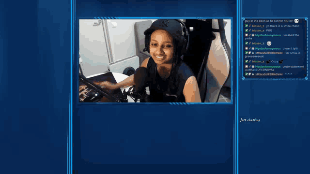 a screenshot of a video game shows a woman wearing headphones and a ny hat