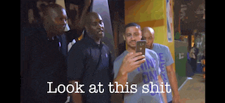 a man taking a selfie with the words look at this shit above him