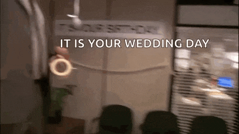 a blurred image of a room with a sign that says it is your wedding day .