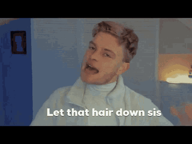 a man says let that hair down sis in front of a blue wall