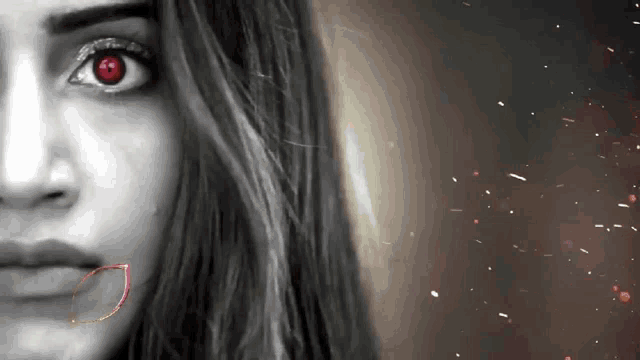 a close up of a woman 's face with red eyes .