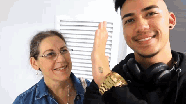 a man giving a high five to a woman with a tattoo on her wrist