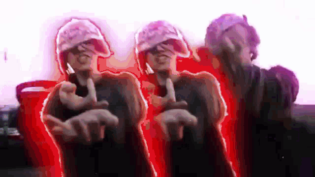 a group of people are standing next to each other and pointing at the camera