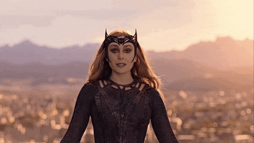 a woman in a black costume with a crown on her head