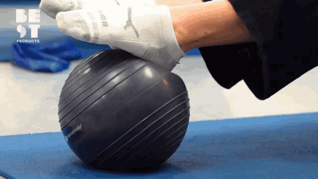 a person wearing a pair of puma socks is putting their foot on a ball