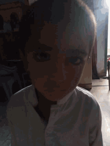 a close up of a woman 's face with a blurred background