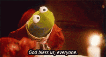 kermit the frog says " god bless us everyone " in front of a candle