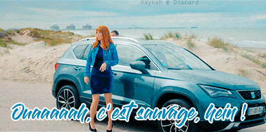 a woman standing in front of a car that says quaaaaah