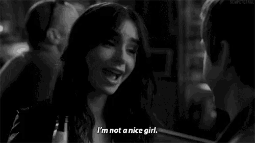 a black and white photo of a woman talking to a man and saying i 'm not a nice girl .