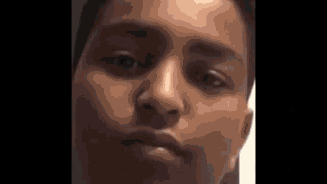 a close up of a person 's face with a serious look on his face .